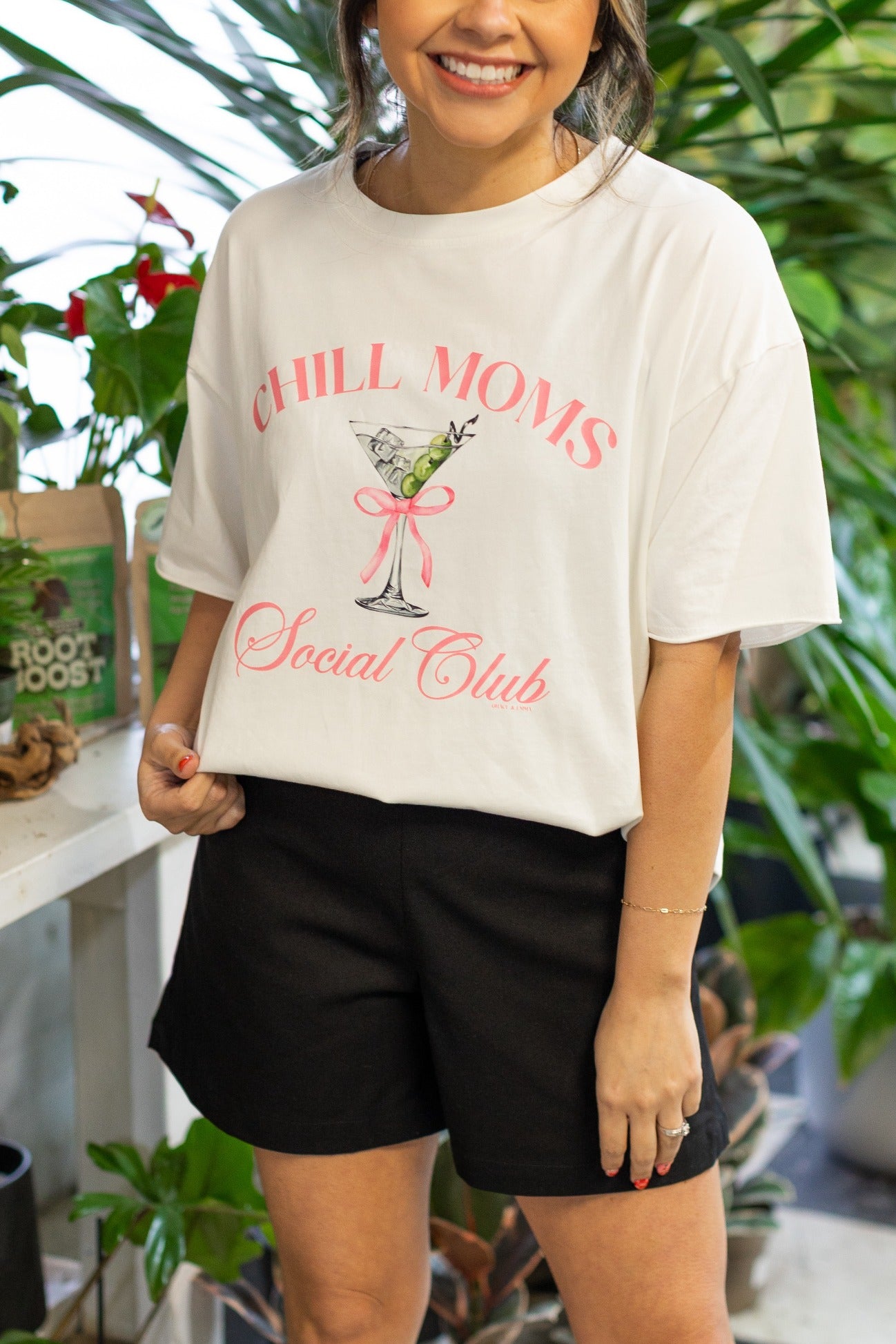 Model wearing the Chill Moms Social Club white tee shirt