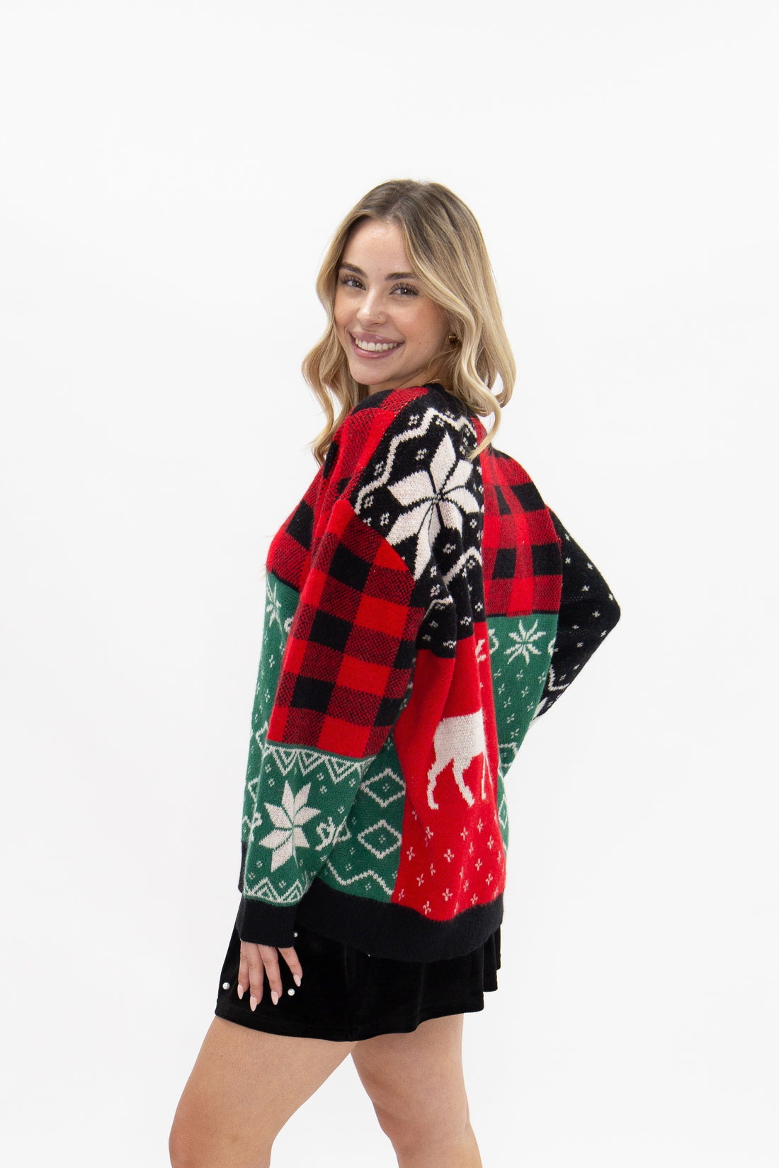Patchwork holiday sweater with reindeer and snowflakes.