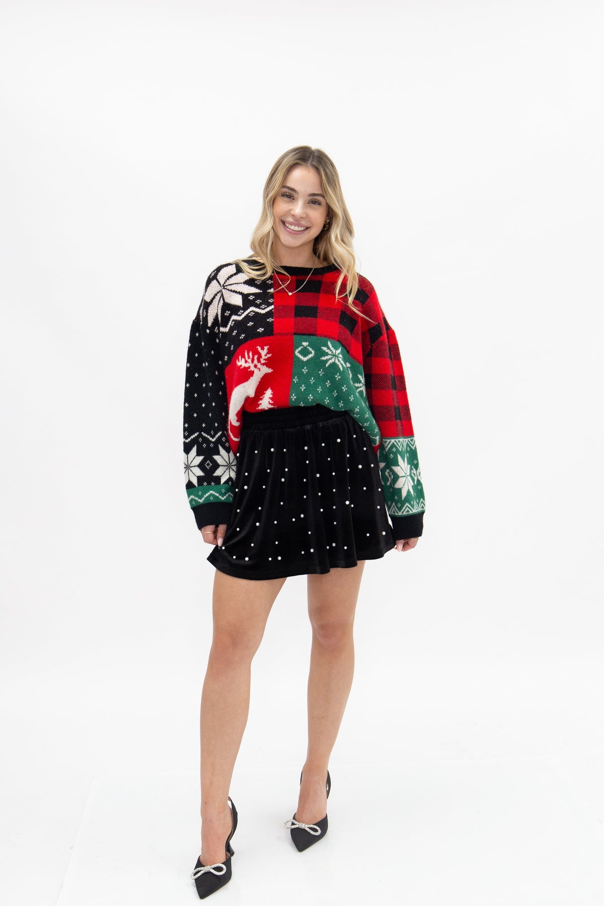 Patchwork holiday sweater with reindeer and snowflakes.
