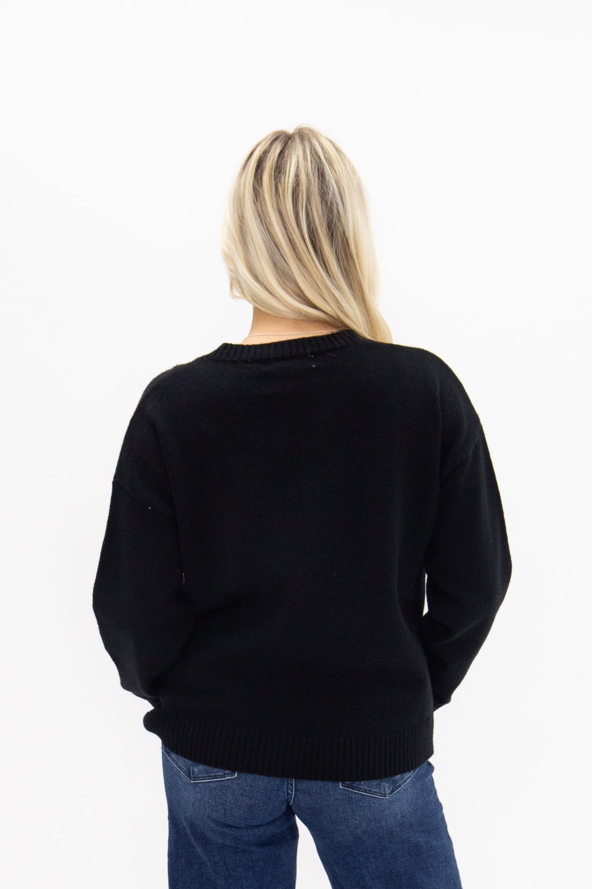 Gold Horse-Bit on a Black Sweater