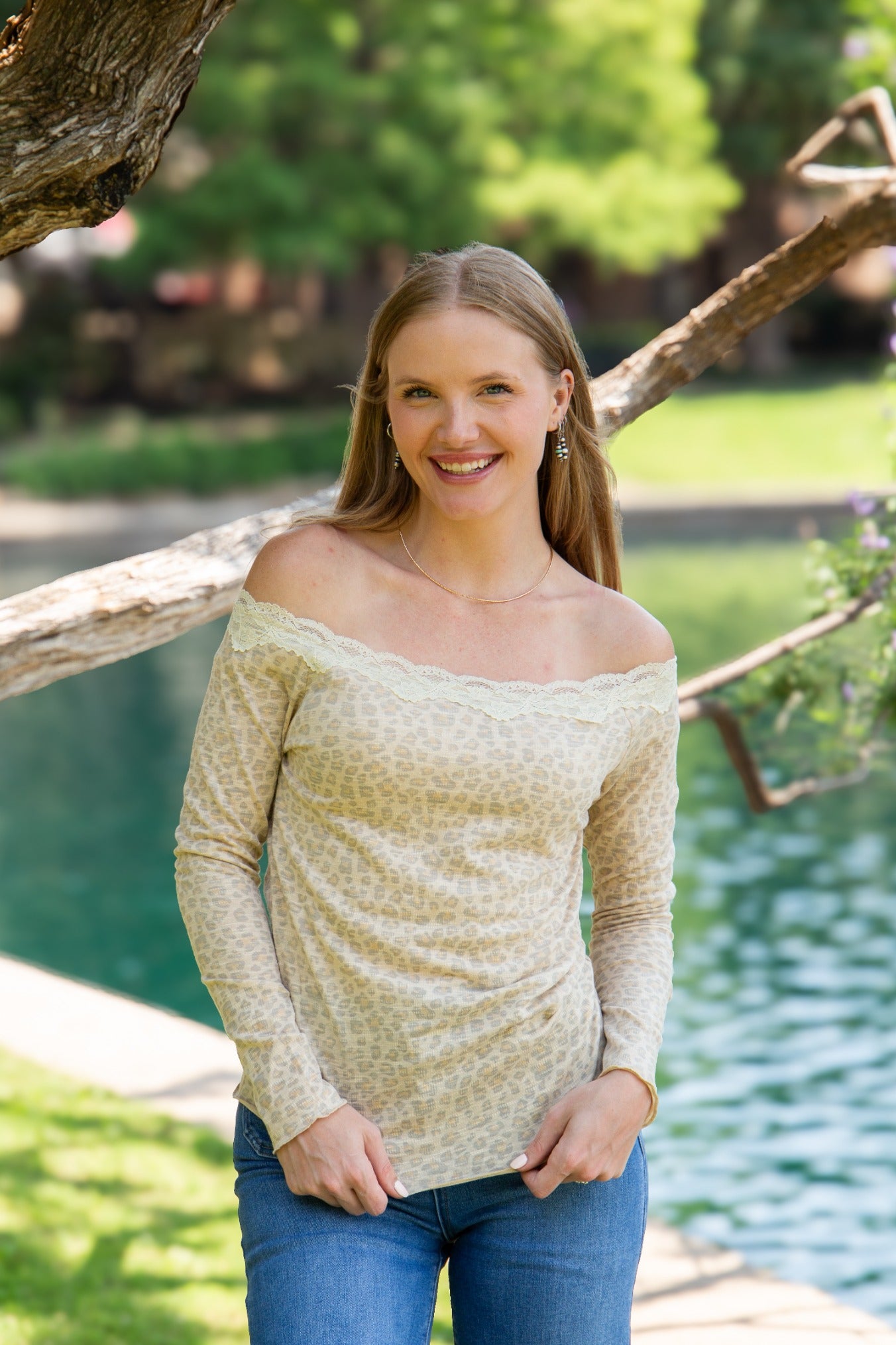 Leopard off-the-shoulder top styled with denim, close-up of lace trim neckline